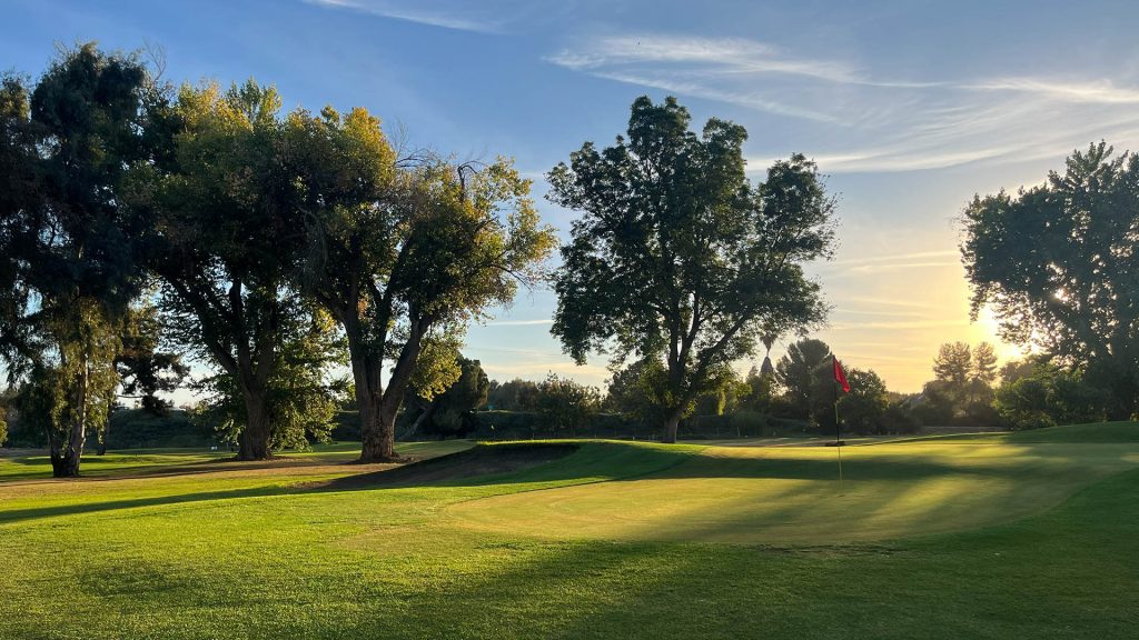 Sunset over a Lemoore Golf Course fairway with tee markers, trees, and golden Central California light.